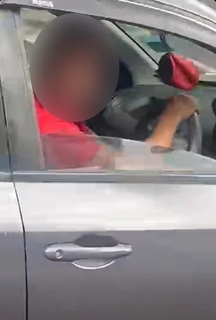 其中一名涉案的宝腾轿车司机在事发时，还回瞪现场拍摄视频民众。（图：视频截图）