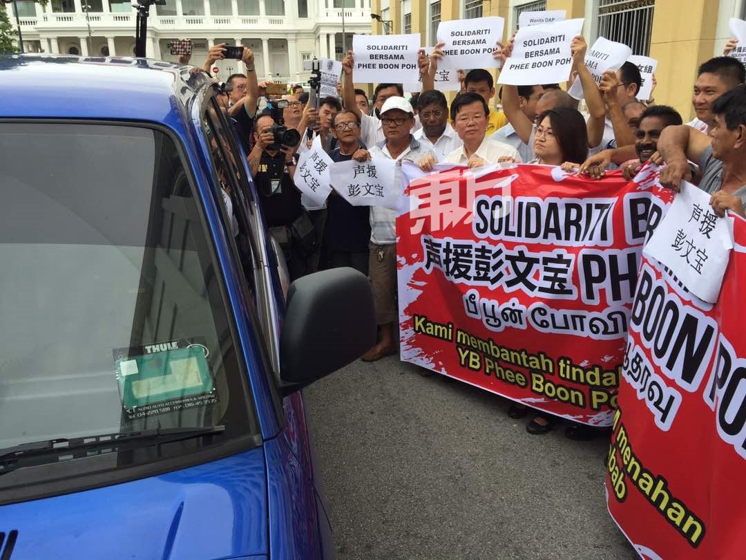 行动党领袖及支持者们围在反贪会的车前，声援车内的彭文宝。（摄影：吴维康）