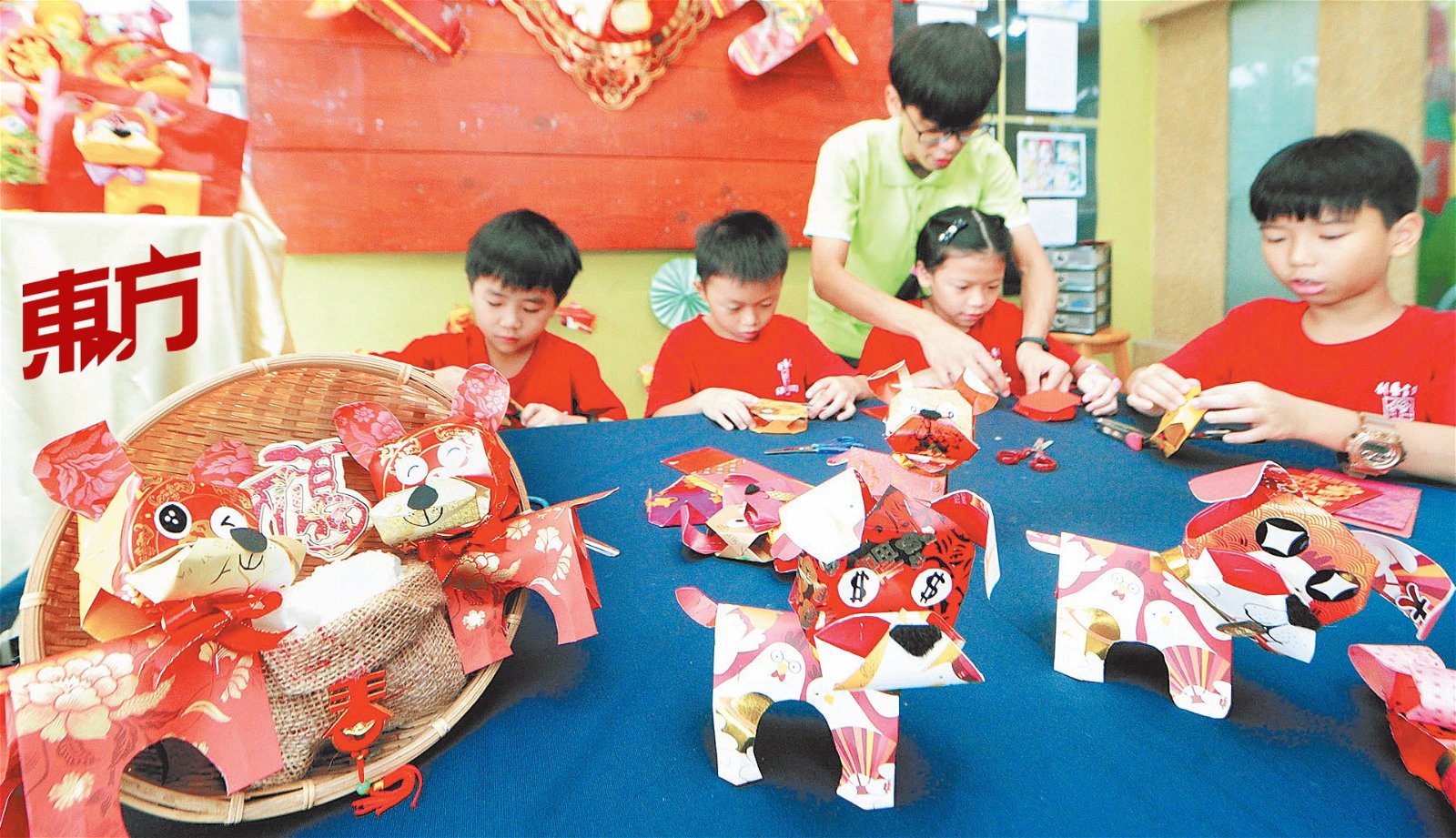 来自新山的创艺画苑美术老师郑伟翔趁著农历新年来临前，运用红包封教导孩子们制作简单却可多变的狗狗立体装饰。