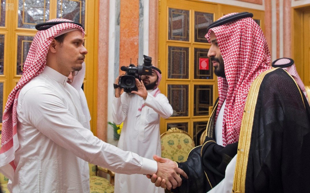 沙地王储穆罕默德（右）与哈苏吉长子萨拉赫握手，后者目无表情。