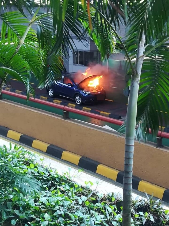 一辆新加坡注册蓝色本田轿车周六下午在新山关卡出境处失火燃烧。（图片取自面子书）