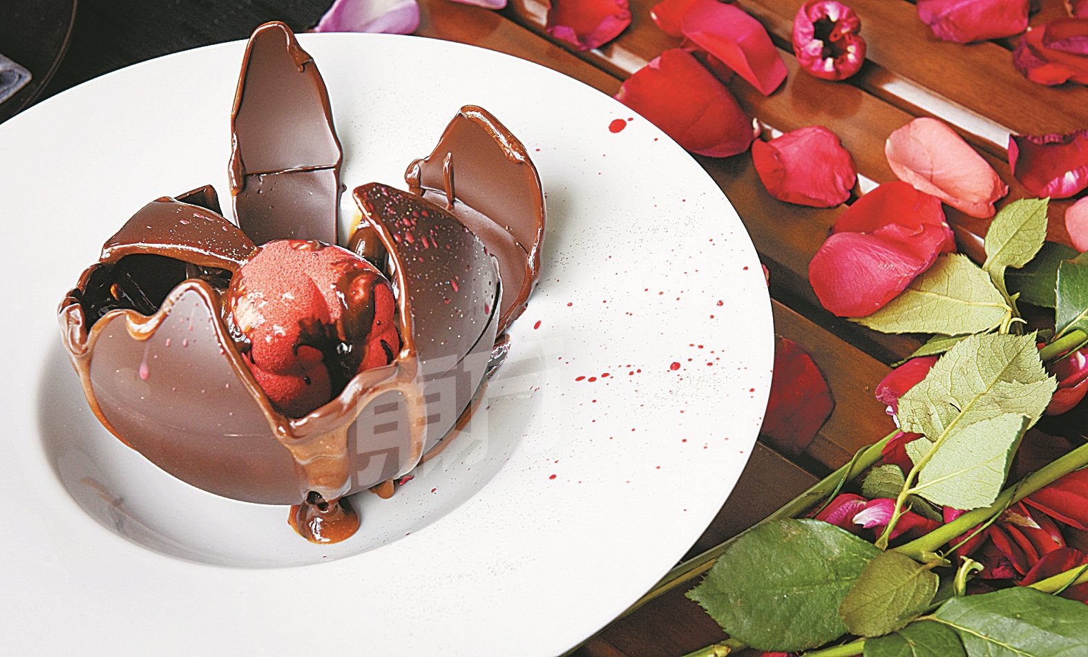 林佩琦和袁锦伦首尝W Hotel的情人节甜品“100% of Love”，由64%的黑巧克力砌成的原方体、淋下热巧克力融化后，里头有36%的心型玫瑰白巧克力奶油冻，期待你来一亲芳泽。
