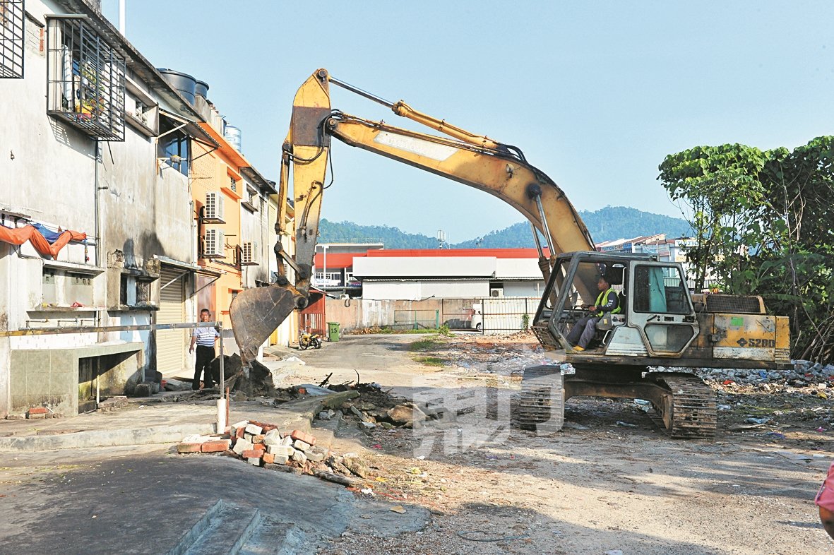 附近地主赞助挖泥机，帮助地方政府拆卸悬而未决多年的违建设施。（摄影：颜泉春）