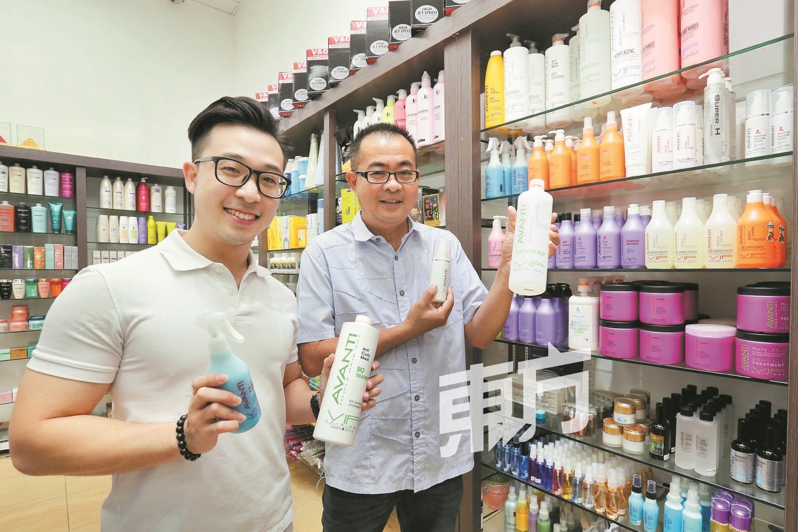 颜联永（ 右） 和颜腾辉两父子联手经营自家品牌美发产品。（摄影：刘维杰）