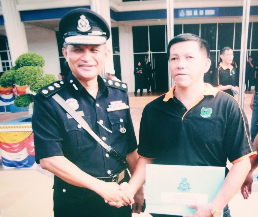 李甫明（右）热心参与大山脚志愿治安队，曾获威中警区主任阿兹曼颁发表扬奖。