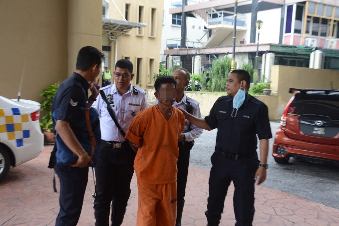 警员押送身穿橙色囚服的嫌犯抵达法庭申请延扣。