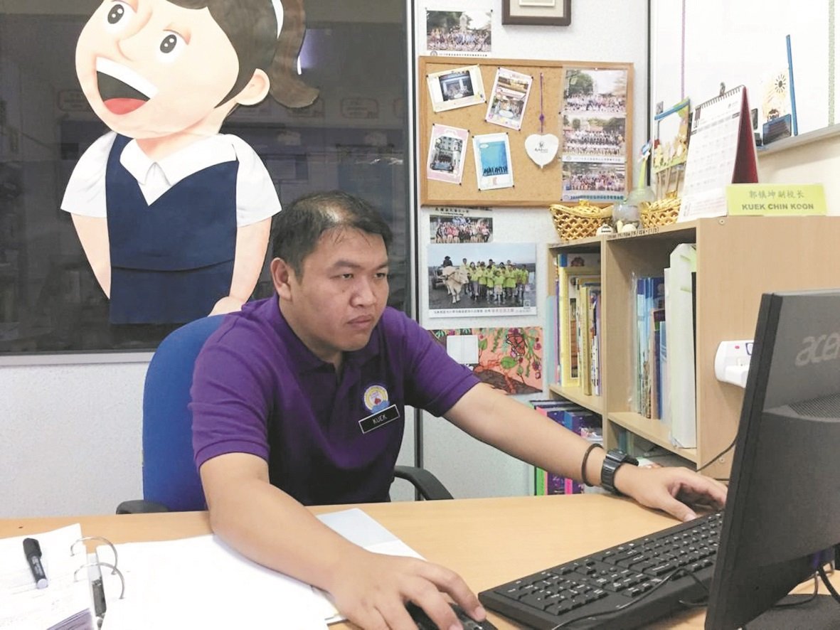 郭镇坤怀著一颗感恩的心带领启智班学生，其办公座位上也贴满了与学生们的合照。