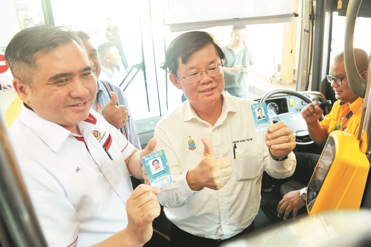 交通部长陆兆福（左起）与槟州首长曹观友推介珍珠卡时，呼吁民众上下巴士时记得刷卡。（档案照）