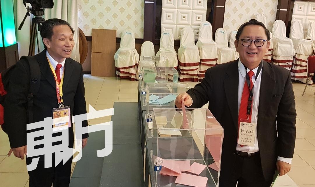 1号总会长候选人锺来福（右）为自己投下一票。