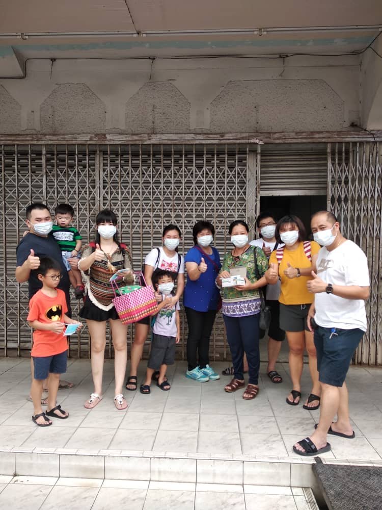 三宝井乡理会主席张森兰（右4）分发口罩予民众，并呼吁民众多喝水及照顾健康。