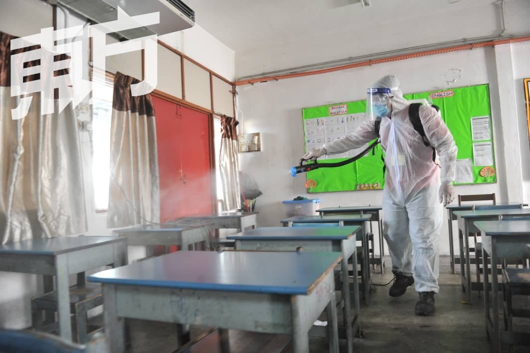 消毒人员穿上防护服，进入课室全面消毒。（摄影：连国强）