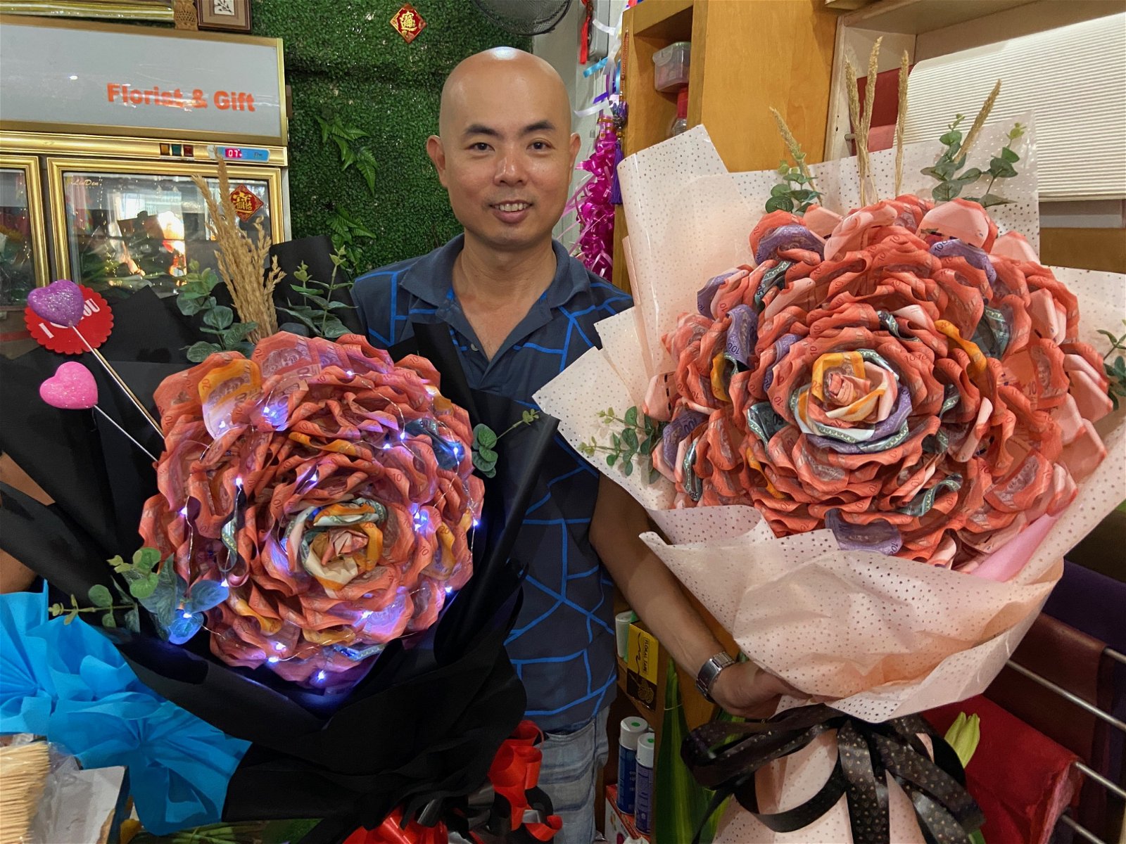 亿花苑负责人郭隆华向记者展示，使用钞票制成的巨型玫瑰花束，他坦言，该花束的价格不菲。