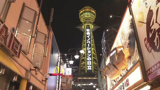 大阪市内的通天阁点亮代表警示的黄灯。