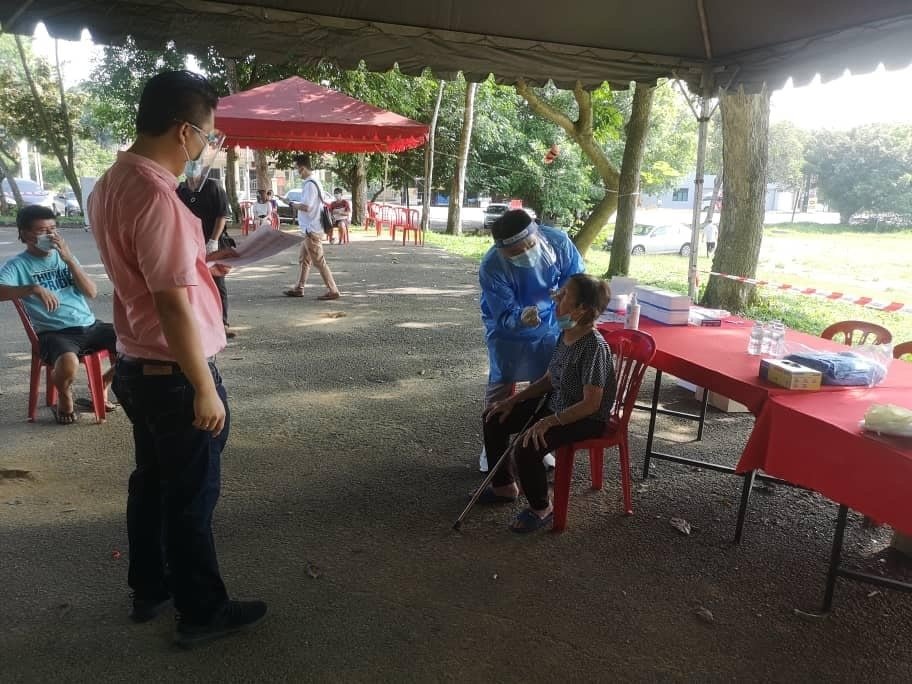 马接峇鲁红新月会获得热心人士赞助，为175名马接峇鲁新村村民进行免费新冠肺炎检测，站者左为韩胜衍。