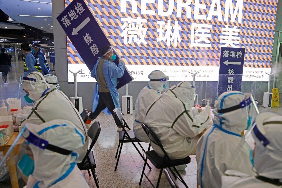 上海市疫情防控工作领导小组办公室周三宣布，12月8日（周四）零时起，上海对来沪返沪人员抵沪后不再实施“落地检”。在铁路上海虹桥站，工作人员周三晚拆除“落地检”指示牌。（图取自中新社）