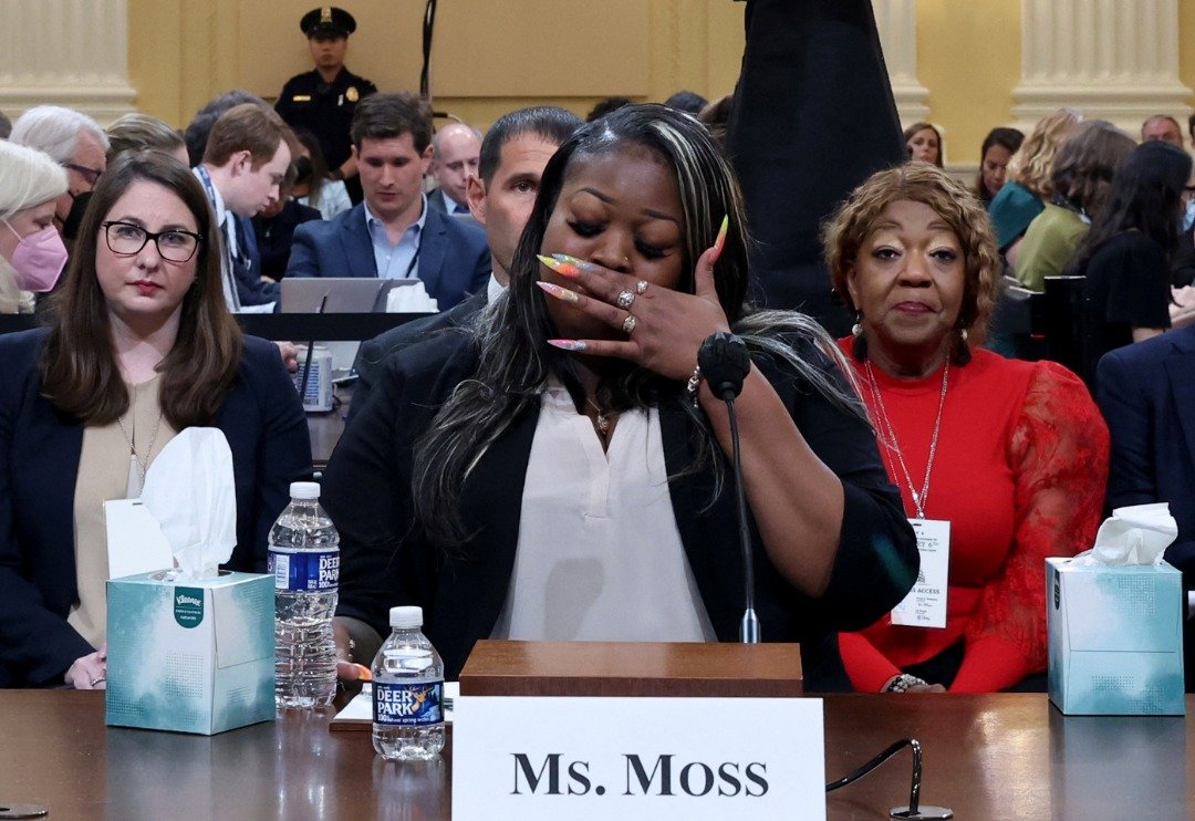 佐治亚州前选举工作人员莫斯在作证期间，谈到自己和亲人被特朗普支持者视为威胁目标时悲从中来，而其母亲弗里曼（红衣者）就坐在她身后。（图取自路透社）