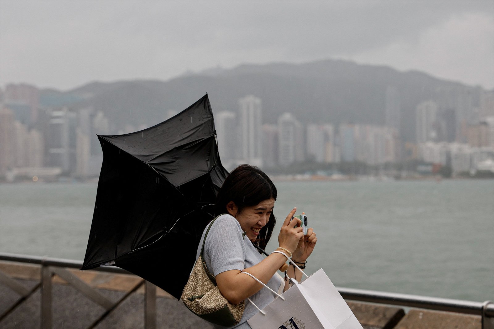 超强台风“苏拉”来势汹汹，但无阻民众在维多利亚港拍照。（图取自路透社）
