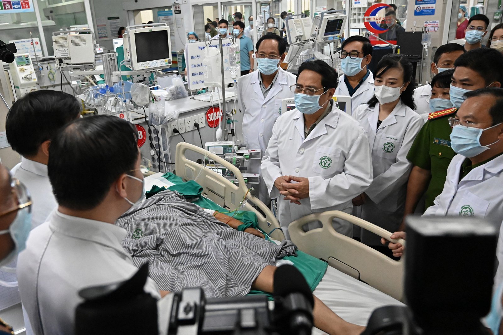 越南总理范明政（中）周三到河内的白梅医院探望伤者。（图取自法新社）