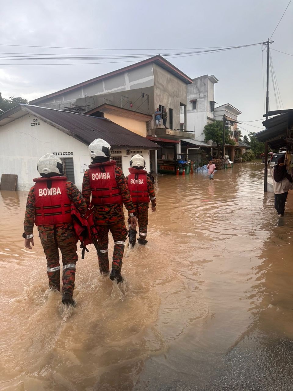 消拯员进入梳邦马来甘榜巡视和评估水灾灾情。
