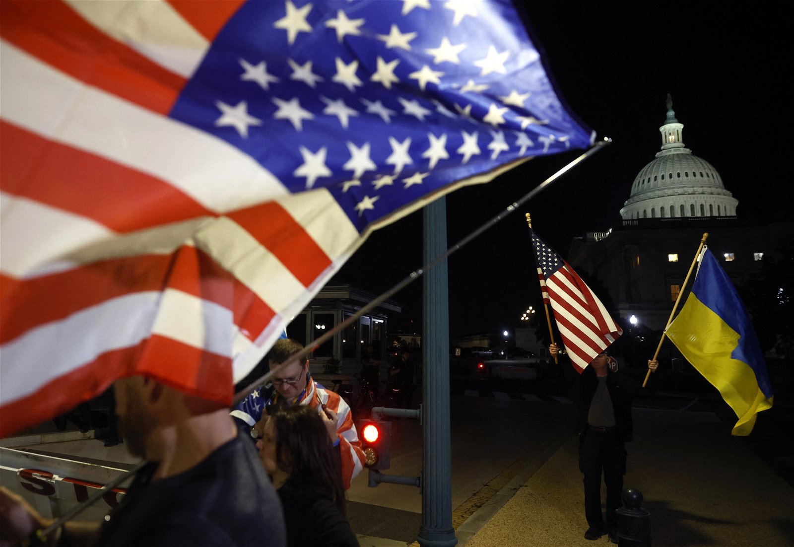美国对乌克兰的援助计划当地时间周二获得联邦参议院通过后，乌克兰的支持者在华盛顿的国会山庄外集会，挥动美国和乌克兰的国旗庆祝。（图取自法新社）
