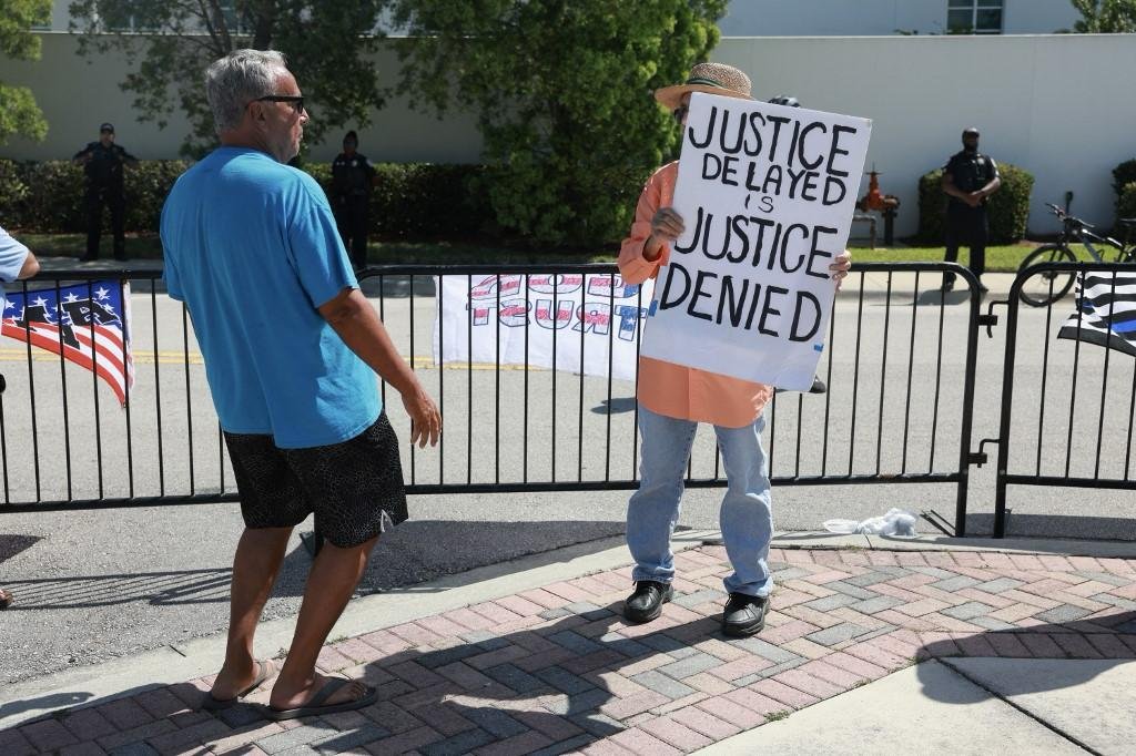 特朗普的支持者和非支持者，周四在佛罗里达州皮尔斯堡的高级美国法院外对峙。（图取自法新社）