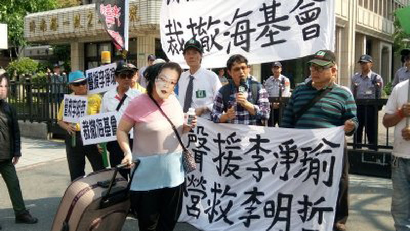 民间团体台湾办公室周一在陆委会大楼前上演行动剧，声援李明哲的妻子李净瑜，呼吁台湾政府营救李明哲。
