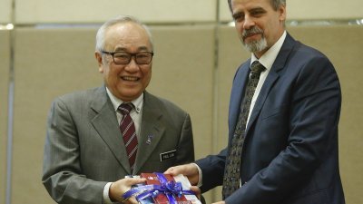 史蒂芬（右）在2017年国际人权日论坛开幕上，赠送纪念品予刘胜权。