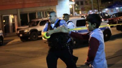 1名芝加哥警察2日在该市的小村区枪击案现场拉起封锁线。