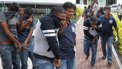 3名嫌犯被警方押往怡保推事庭时，拉高上衣遮掩脸部。（摄影：李家俊）