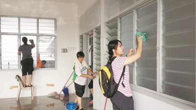 为让学生在新校舍有个舒适干净的环境，家长和学生携手为巴生启明华小进行清理工作。