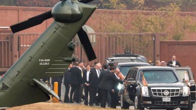 特朗普韩国国会讲话文配图：随行的白宫高级官员与在车内的特朗普交谈。特朗普原打算在不对外公布的情况下，搭乘直升机前往韩朝非军事区，却因天气恶劣而取消计划。-路透社-