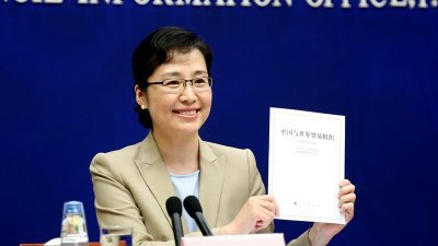 中国国务院发言人袭艳春周四在北京的新闻发布会上，向媒体展示《中国与世界贸易组织》白皮书。