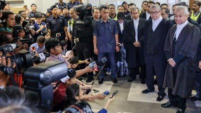 总检察长汤米汤姆斯马来语不好，而被要求撤换。图为汤米（右）在记者会上被纳 吉支持者叫嚣，而被迫转移 地点召开记者会。