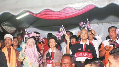  旺阿兹莎（左2起）、马哈迪伉俪及末沙布等，在讲座会结束之际，齐挥动国旗唱爱国歌曲。