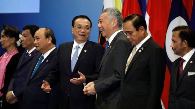 中国－东盟领导人会议周三在新加坡会展中心举行，与会领导人在台上合照期间，中国总理李克强（中）和新加坡总理李显龙（右2）开心交谈。