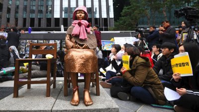 韩国民众周三在首尔日本大使馆前、象征“慰安妇”的少女像周围示威，反对韩国前政府和日本在2015年签署的“日韩慰安妇问题协议”。