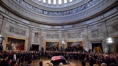 已故美国参议员麦凯恩的灵柩，周五停放在木质的灵柩台上，供出席者悼念。麦凯恩之前，美国历史上仅有30位公民，获得在国会圆形大厅停灵供人瞻仰的哀荣，麦凯恩的重要性不言可喻。