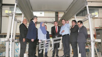 陆兆福（右4）见证见证国家基建公司与史格米工程商签署协议后，了解全新的单轨火车车厢 构造。（摄影：骆曼）