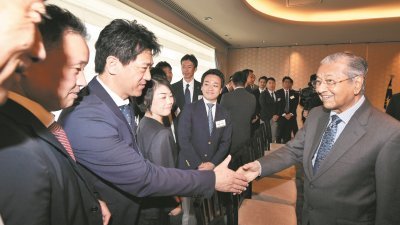 敦马哈迪在日本福冈县进行访问及发表主题演讲后，与当地企业精英握手问好。