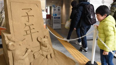 位于鸟取砂丘的砂之美术馆在周日展示的老鼠沙雕维妙维肖，吸引大人小孩。