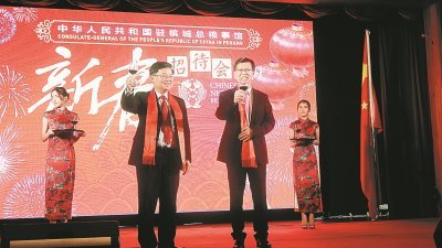 曹观友（左）与鲁世巍为槟城与中国的友好关系，互相敬酒。