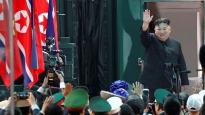 朝鲜最高领导人金正恩，周六下午在越南同登车站步入专列返朝前，向在场人士微笑并挥手道别。