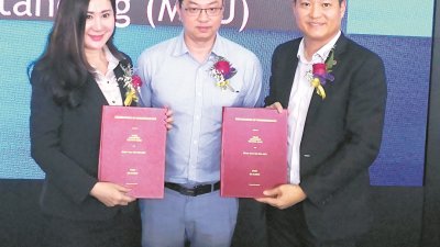 吴年珍（左起）在潘伟斯见证下与陈洺臣交换签署的合作备忘录，联办这次的“5G起航，企业在势”讲座会。