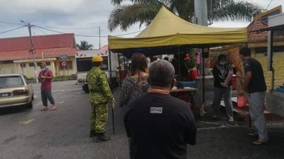 民众排队买食物，现场亦有志愿警卫员驻守。