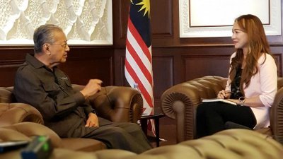 敦马哈迪（左）接受网络媒体《马来亚邮报》主持人聂苏雅妮的专访。   

