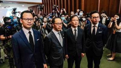 周三下午丧失香港立法会议员资格的杨岳桥（右一）、郭荣铿（左一）、郭家麒（右二）及梁继昌（左二），当天离开立法会会议厅。（图取自香港中通社）