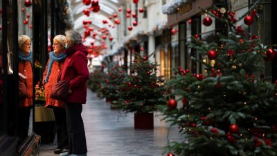 在英国伦敦的伯灵顿拱廊街，两名妇女看著橱窗里的圣诞装饰。（图取自路透社）