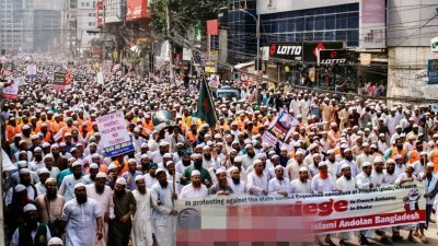 数以千计孟加拉国抗议群众周二在首都达卡示威，有些人践踏印有法国总统马克龙肖像的海报。（路透社）