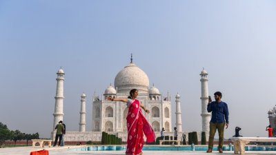 虽然印度新冠肺炎疫情持续恶化，但当局仍于周一重新开放观光胜地泰姬陵。图为泰姬陵重新开放当天，有旅客在该观光胜地拍照留念。
