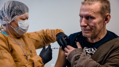 一名流浪汉当地时间上周一，在莫斯科的无家可归者援助组织Nochlezhka的办公室注射“史普尼克V”疫苗。（图取自法新社）